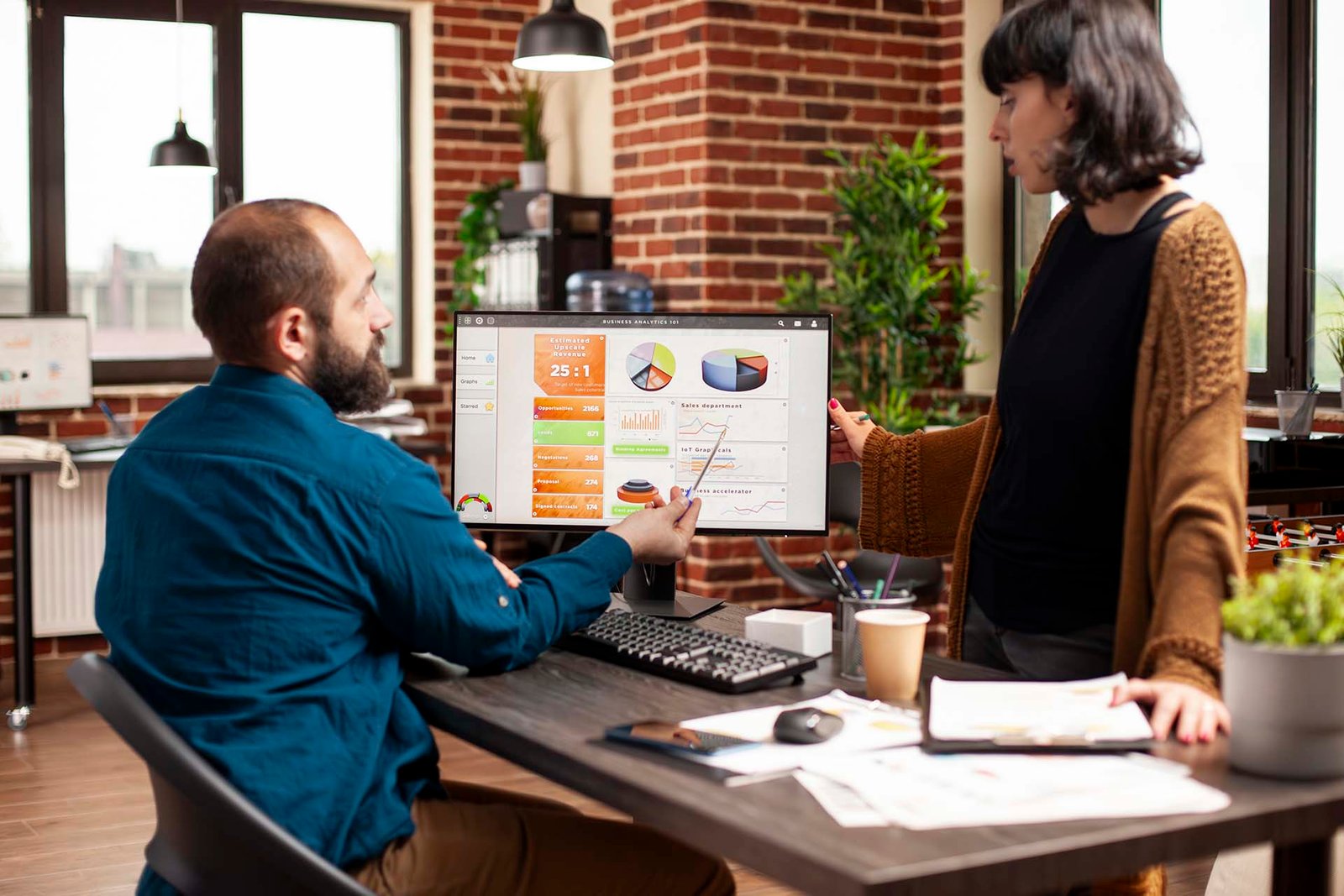 Woman listening to businessman in office